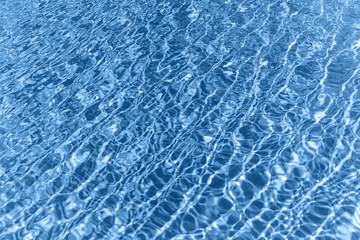Surface of blue shining swimming pool water ripple. Can be used as background.