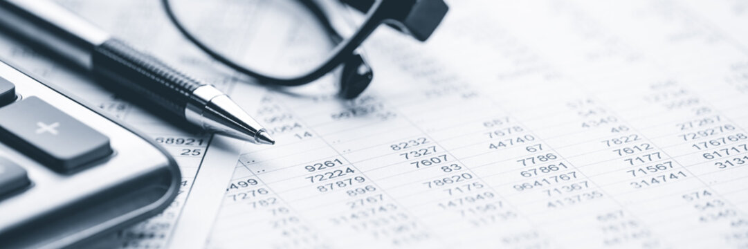 Close-up Pen Calculator And Reading Glasses On Financial Report - Business Accounting Concept