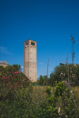 Fototapeta na wymiar Cathedral of Santa Maria Assunta's bell tower under blue sky on island of Torcello, Venice, Italy