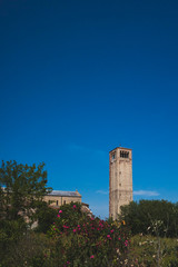 Fototapeta na wymiar Cathedral of Santa Maria Assunta's bell tower under blue sky on island of Torcello, Venice, Italy