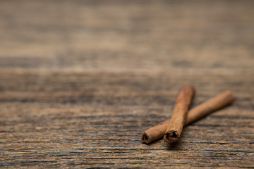 Selective focus of Cinnamon on a  wood background and copy space