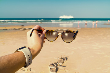 look through sunglasses at the sea beach and cruise ship in warm colors