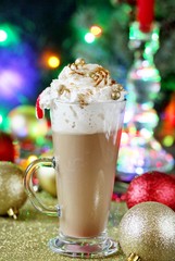 Original coffee with whipped cream is decorated with food confectionery gold balls and food glitters. original decoration idea with food gold. festive mood.