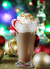 Original coffee with whipped cream is decorated with food confectionery gold balls and food glitters. original decoration idea with food gold. festive mood.