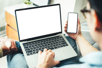 mockup image blank screen computer,cell phone with white background for advertising text,hand man using laptop texting mobile contact business search information on desk in office.marketing and design