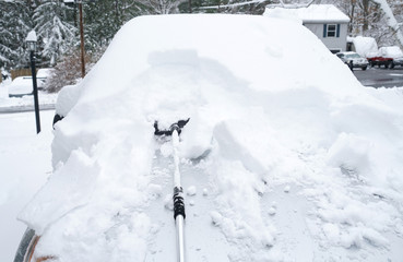 removing snow on the car window after snow storm