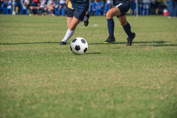 Fototapeta premium Football match in Girls' Under 15 years school soccer tournament. Players are in action of defending and attacking mode.