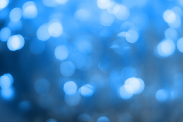 Blurred blue sparkling festive bokeh background. Trendy 2020 year color