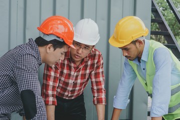 Engineer architecture and worker in safety helmet are talking about problem.