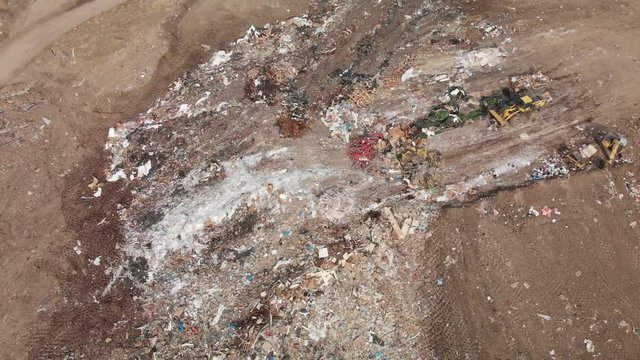 plow moving trash at the landfill