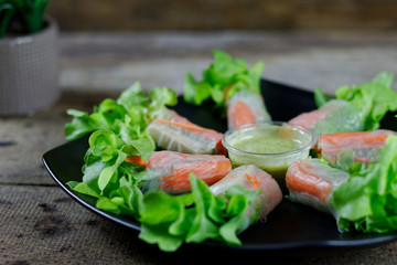 Hydroponic Vegetable Salad Roll Crab stick on black plate with sauce