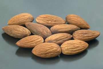 walnut almonds handful close-up on a dark plate. Healthy and protein food