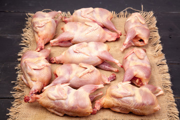Raw quail meat on a wooden background - 307550734