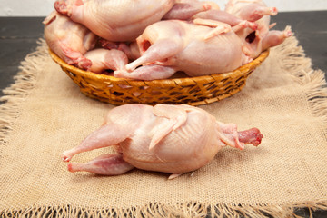 Raw quail meat on a wooden background - 307550750