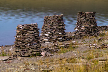 Truncated stone pyramids on the lake.