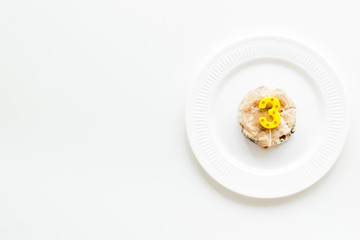 Cat's birthday concept. Pet feed with festive candle in shape of three on white background top-down copy space