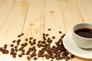 cup of coffee and beans on wooden table