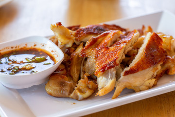 Grilled Chicken in white plate and spicy source