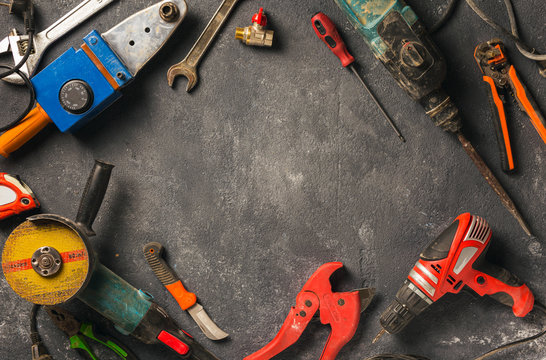Frame of construction worker tools on a dark background top view. Remodel concept