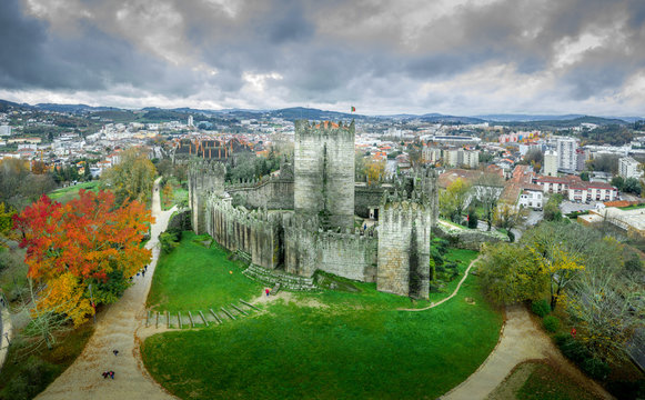 Aerial view of well-preserved medieval buildings hilltop, 10th-century Guimar&atilde;es Castle with its sweeping city views. Restored Dukes of Bragan&ccedil;a Palace, Romanesque S&atilde;o Miguel do Castelo Church
