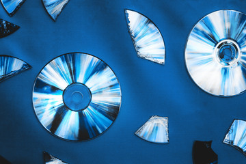 Vintage CD or DVD disk background, old circle discs and treir parts used for data storage, share movies and music.