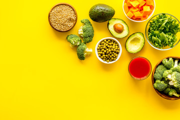 Healthy food. Vegatables and fruits on yellow background top view frame copy space