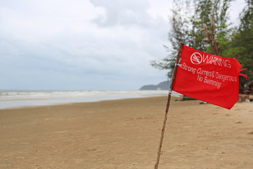 Red flag Warning Strong Current and Dangerous No Swimming in sea on Storm. Red flag flying on beach.