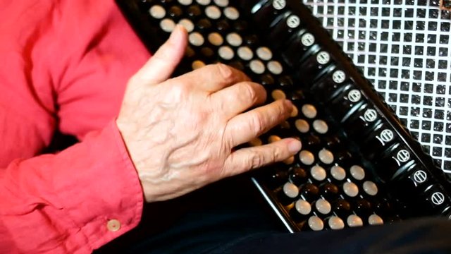 Close-up of a musician hand masterfully performing on harmonica