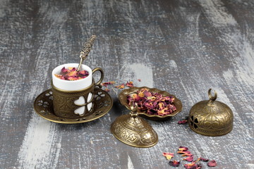 Dried Rose petals for making Rose tea and a cup of tea