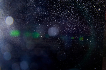 Abstract dust explosion and flash with illumination on a black background