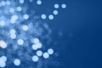Abstract dark blue colored blured sparkling background. Color of the year 2020. Main color trend concept.