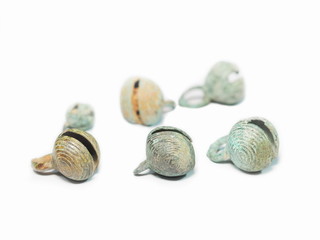 view of ancient bronze little bells covered with green patina isolated on white background.