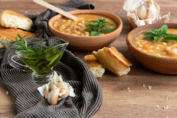 Served traditional hot beans soup with corn bread, garlic and olive oil. Vegetarian healthy dish, vegan food