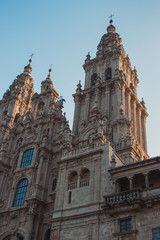 Fototapeta na wymiar Famous Cathedral of Saint James in Santiago de Compostela, Spain. Catholic church in the morning light on blue sky background. Pilgrimage centre. Religious heritage. Medieval architecture.