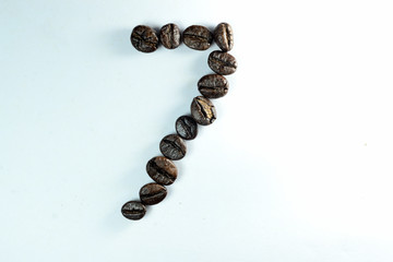 Coffee Been, the number seven is formed with coffee beans in white background