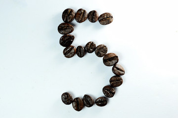 Coffee Been, the number five is formed with coffee beans in white background