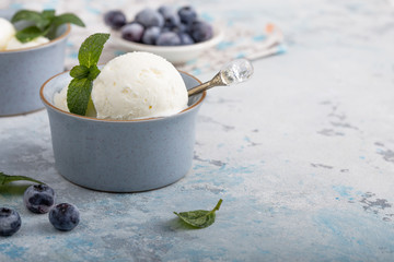Homemade  vanilla ice cream with fresh mint. Sweet berry summer dessert. Concrete background copy space