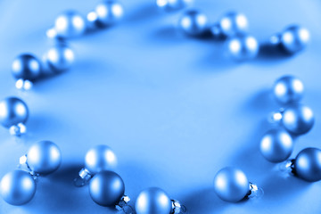 From above shot of bright glittering baubles composed in row on pink background.