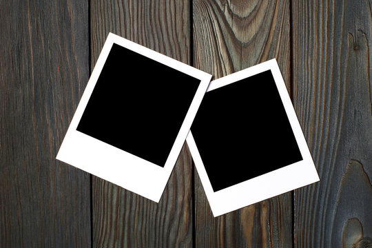 Two square blank photocards on dark wooden background