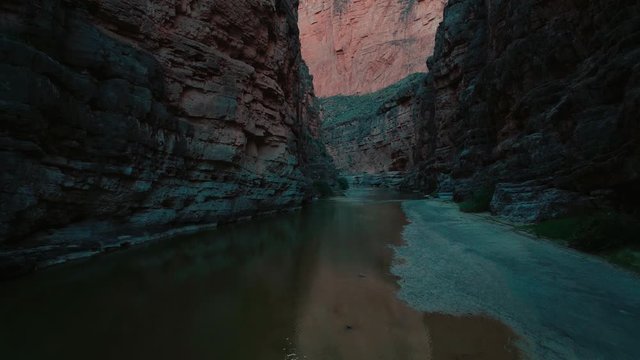 Low pull back over the Rio Grande river in the river canyon near Mexico and Big Bend Texas