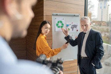 Grey-haired manager in elegant suit looking serious