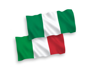 National vector fabric wave flags of Italy and Nigeria isolated on white background. 1 to 2 proportion.