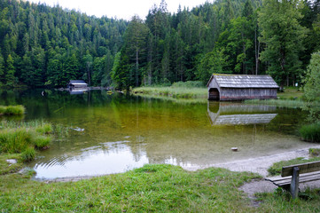 Lake in the forest. Clean water. Boat garage on the shore of the lake.