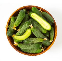 cucumbers in a bowl isolated on white