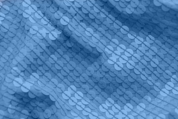Shiny fabric with sequins, abstract background toned blue color.