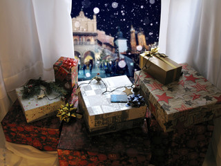 Christmas scene with gifts near window in room overlooking night city