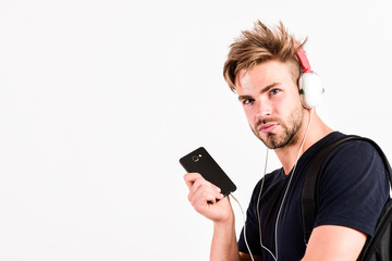New technology. copy space. unshaven man listening music in headset. sexy muscular man listen sport music. man in earphones isolated on white