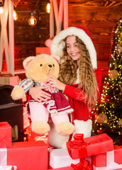 Fototapeta na wymiar Christmas eve. Shopping before holiday. Child with gorgeous long hair celebrating new year. Christmas gifts concept. Pick up perfect present. Boxing day. Happy holidays. Girl celebrate christmas