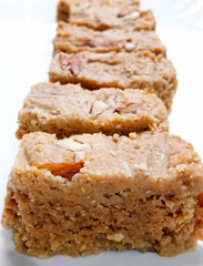 Indian Diwali Sweet Food Kalakand Also Know as Halwa or Mawa Kalakand is a Creamy Delicacy Made From Paneer or Cottage Cheese, The Dish Originated in Alwar, Rajasthan. Isolated on White Background
