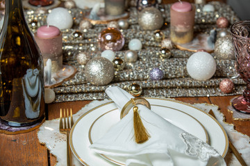 Place setting for Christmas in white and gold tones
